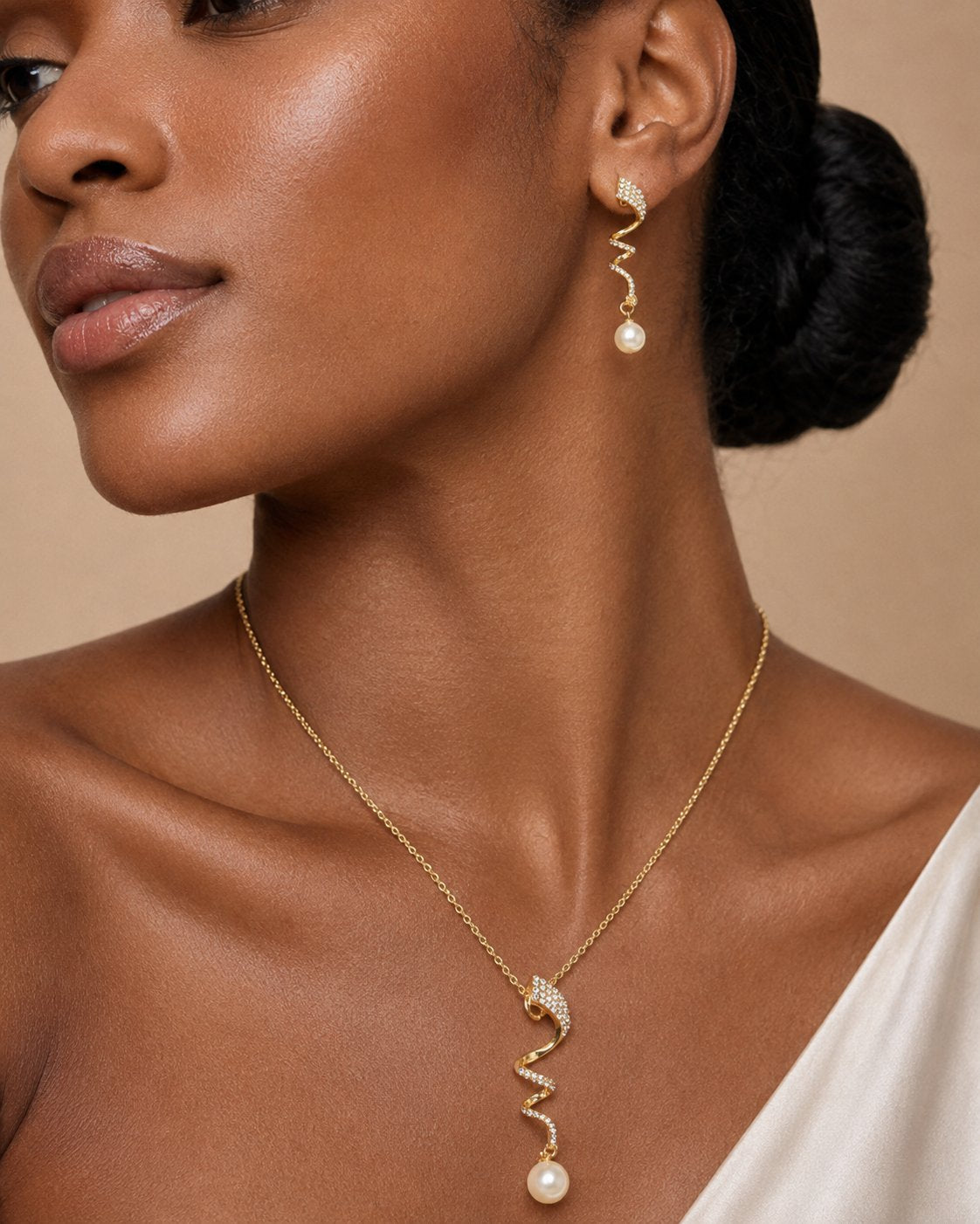Macro detail of the Aurelia pendant and earring worn on the ear and neck
