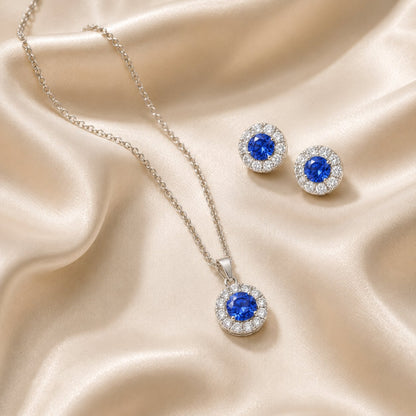 Celeste Sapphire Halo Set necklace and earrings, flat lay
