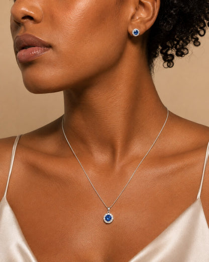 Model wearing the Celeste Sapphire Halo Set necklace and earrings, close up