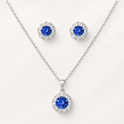 Celeste Sapphire Halo Set styled on satin fabric